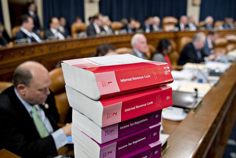 Tax code books sit on a table as the House Ways and Means Committee begins markup of the GOP tax bill on Nov. 6.