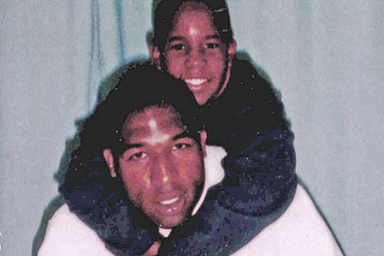 Anthony Wright and his son in the 1990s. Wright is serving life in the attack on a Nicetown woman, 77. DNA evidence challenges case.