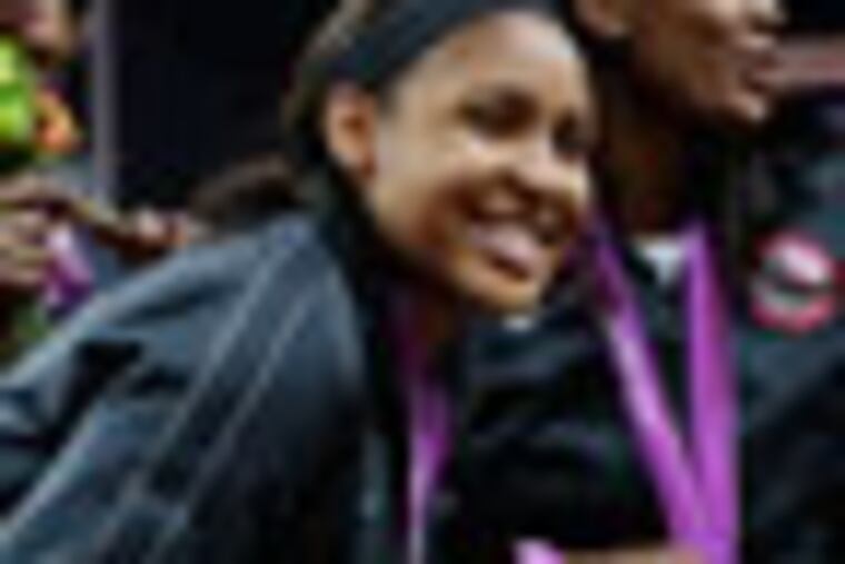 USA's Maya Moore, left, celebrates with teammates after they received their gold medals after defeating France in a women's gold medal basketball game at the 2012 Summer Olympics, Saturday, Aug. 11, 2012, in London. (AP Photo/Eric Gay)
