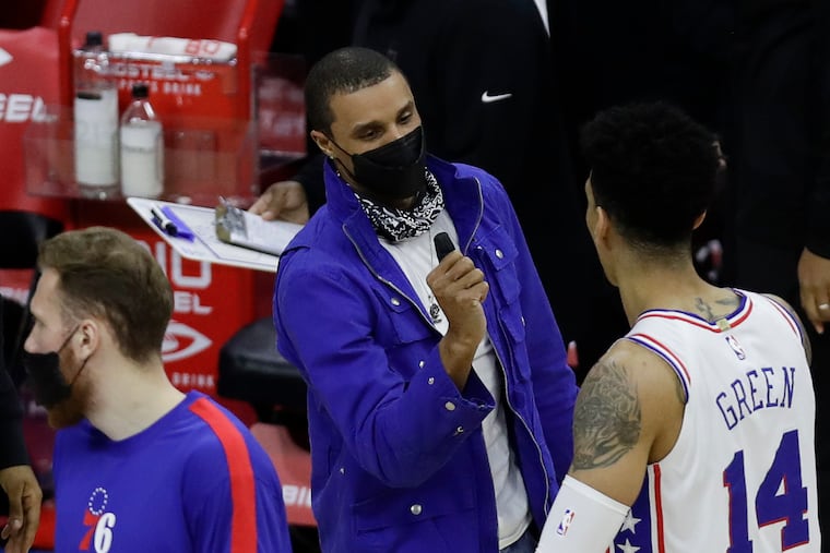 New Sixers guard George Hill with teammate Sixers forward Danny Green during a timeout against the Minnesota Timberwolves on Saturday in Philadelphia.