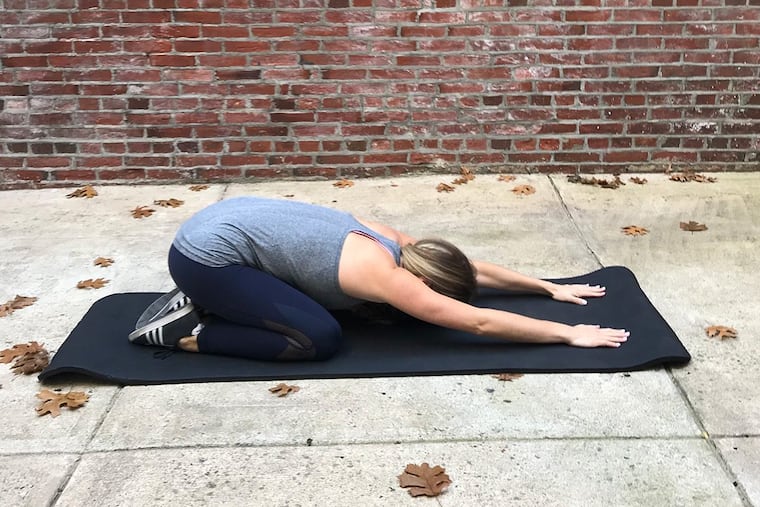 Ashley Greenblatt demonstrates a child’s pose.