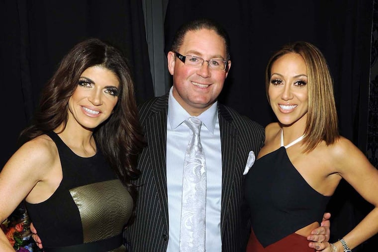 Teresa Giudice, left, and Melissa Gorga, right, of Real Housewives of New Jersey fame flank Atlantic City attorney James Leonard Jr. He represents both, but Teresa's needs take up most of his time.