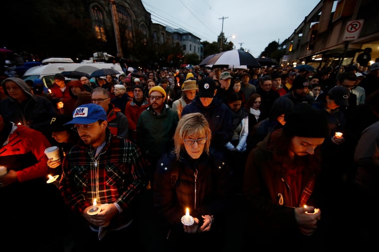 People hold candles as they gather for a vigil in the aftermath of a deadly shooting at the Tree of Life Congregation, in the Squirrel Hill neighborhood of Pittsburgh, Saturday, Oct. 27, 2018.
