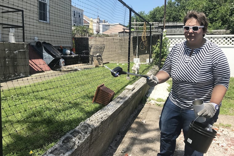 Patty Pat Kozlowski, the Republican candidate for the 177th Legislative District, picks up a needle outside her home in Bridesburg. Kelly Brennan / Staff .