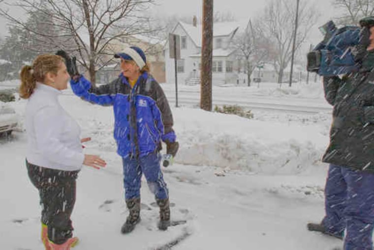 CBS3 meteorologist Carol Erickson wipes snow from the face of Stevie Logothetis, manager of the Colonial Diner on Broad Street in Woodbury, before a live report from the diner's parking lot. Cameraman Alan Wheeler captured the snowy scene Wednesday.