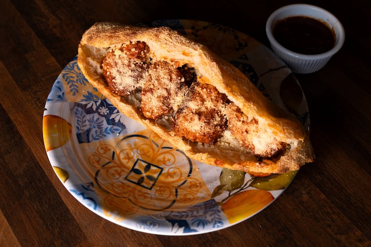 A meatball sandwich sits on a table at Italian Family Pizza on Monday, July 21, 2025, in Philadelphia. The bread is made using pizza dough while the meatballs are a combination of pork and veal.