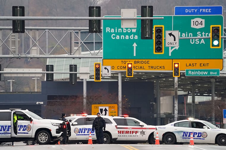 Law enforcement personnel block off the entrance to the Rainbow Bridge on Wednesday in Niagara Falls, N.Y.