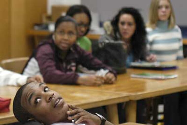 Jordan Burnham looks back at the blackboard as mental health awareness program manager Coleen Coffey (not shown) writes his Facebook info down. Burnham talked about his life to students at Pottsgrove High School on Wednesday. (Tom Gralish / Staff Photographer)