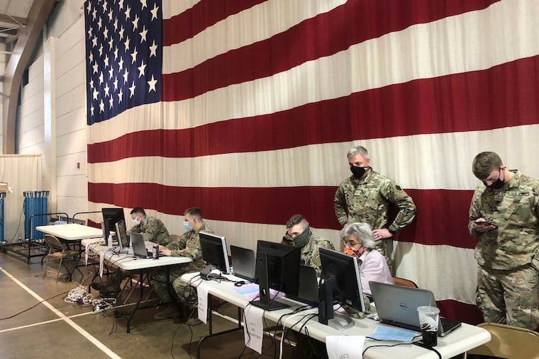 Members of the West Virginia National Guard monitor statewide efforts to distribute COVID-19 vaccines Thursday, Jan. 14, 2021, at the National Guard Joint Forces headquarters in Charleston, W.Va. West Virginia has emerged an unlikely success in the nation’s otherwise chaotic vaccine rollout. Officials also credit a 50-person command center at the state’s National Guard headquarters just outside the capital of Charleston.