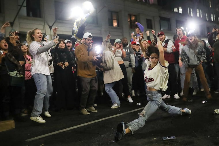 Fans celebrate near Broad and Sansom Streets in Philadelphia after the Phillies defeated the Padres to move on to the World Series on Sunday.