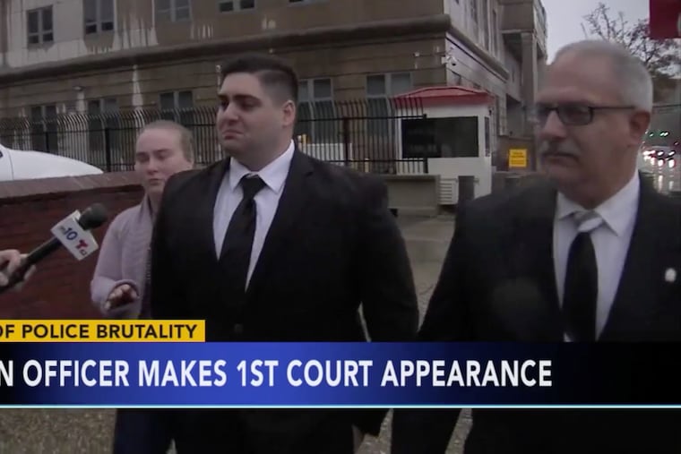 Shown in this file photo, Camden County Police Officer Nicholas Romantino (center), 26, of Egg Harbor, was acquitted of filing a false police report. A mistrial was declared on a civil rights charge that alleged that Romantino punched an unarmed suspect during an arrest.