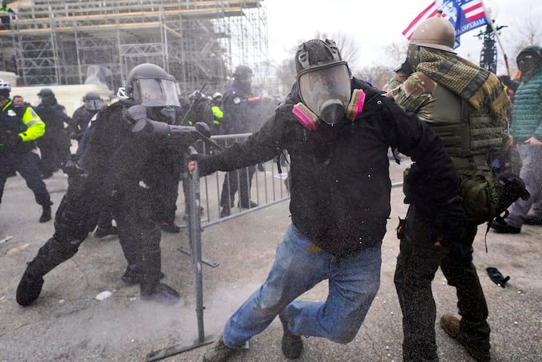 Insurrectionists loyal to President Donald Trump confront police as they storm the U.S. Capitol on Jan. 6, 2021, in Washington.