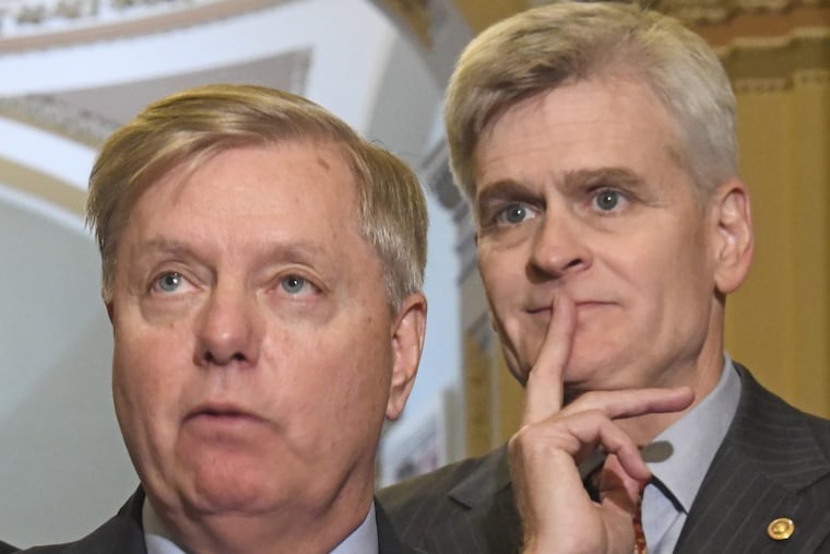 United States Senator Lindsey Graham (R-S.C.) speaks to reporters outside the US Senate Chamber following the Republican weekly luncheon caucus in the US Capitol on Sept. 19, 2017 in Washington, D.C. Looking on from the right is US Senator Bill Cassidy.