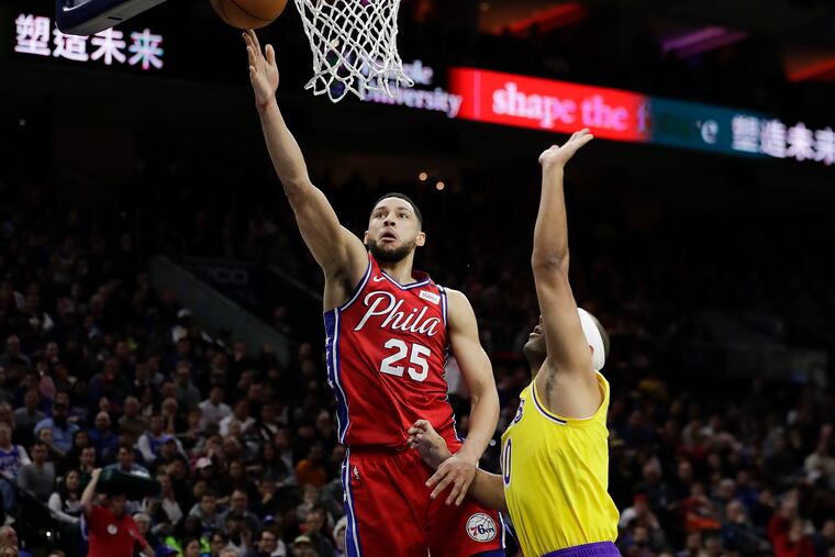 Ben Simmons scores past Lakers forward Jared Dudley in January.
