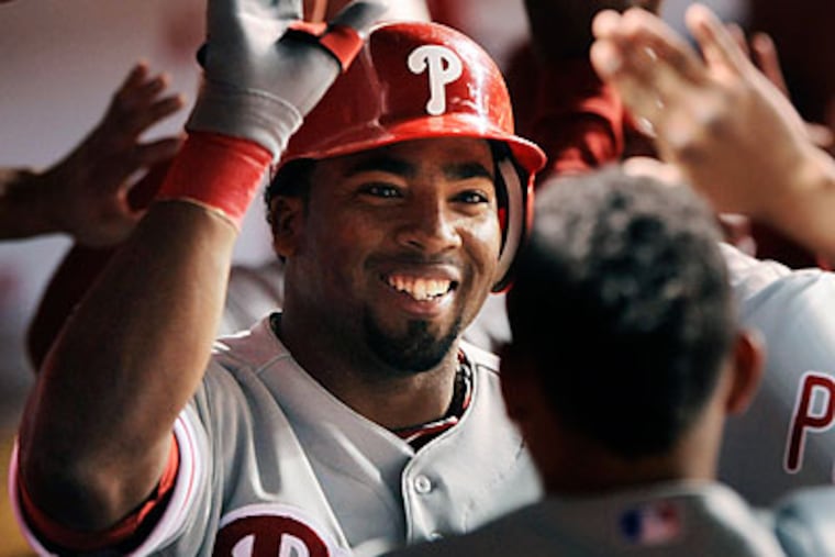 Hector Luna celebrates with teammates after hitting a grand slam in the ninth inning. (Paul Beaty/AP)