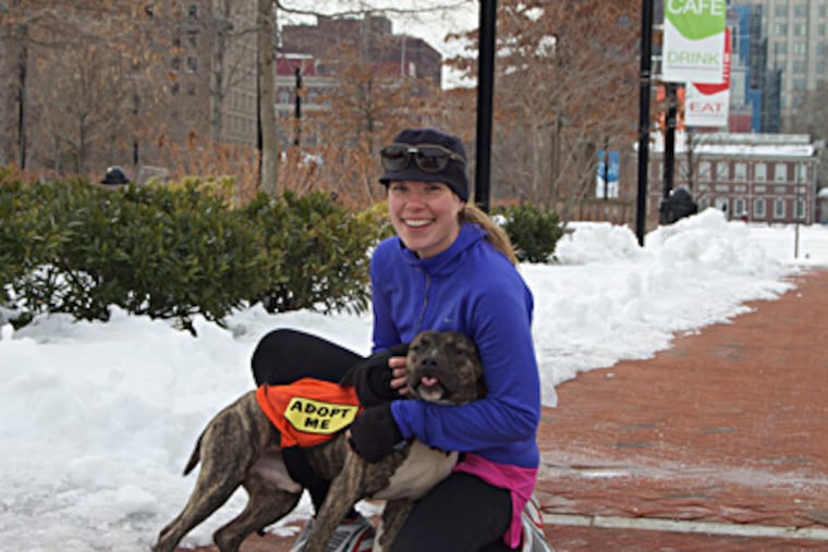 Carrie Maria trains with one of her partners. She founded a group that borrows dogs from shelters as running mates, which helps calm the dogs and make them more adoptable.