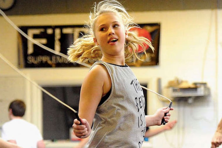 Amelia Enfinger, 14, warms up before a CrossFit class. (JOHN HELLER / Pittsburgh Post-Gazette)