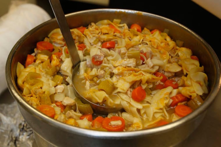 Mary Claxton, production assistant at Western Reserve Hospital, ladles out quart containers of chicken soup in the hospital's kitchen on Tuesday, March 10, 2015, in Cuyahoga Falls, Ohio. The soup is part of the hospital's new Soup to Go program for patients who undergo outpatient surgery. (Karen Schiely/Akron Beacon Journal/TNS)