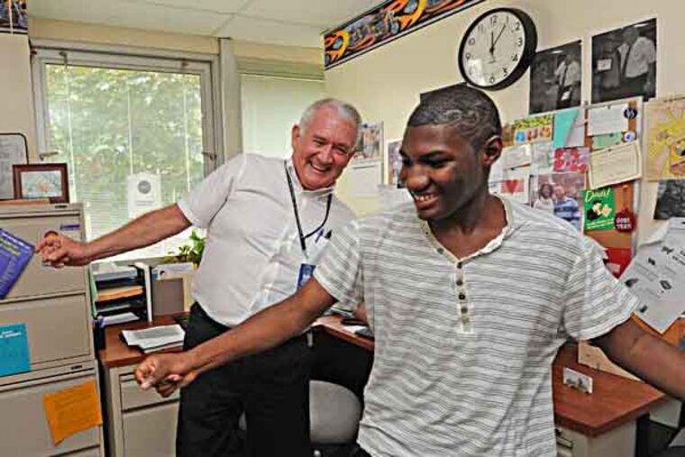 At Collingswood High School, guidance counselor Dennis Gaughn goes above and beyond his job description to help kids, photos taken on 5/21/13. Here, he dances with Faison Sanders, 16, who routinely comes to Gaughn's office to teach him moves and use Gaughn's cologne. ( APRIL SAUL / Staff )