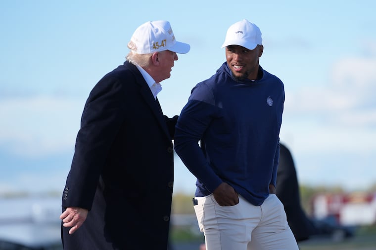 President Donald Trump walks with Philadelphia Eagles running back Saquon Barkley before boarding Air Force One at Morristown Municipal Airport on April 27 in Morristown, N.J.