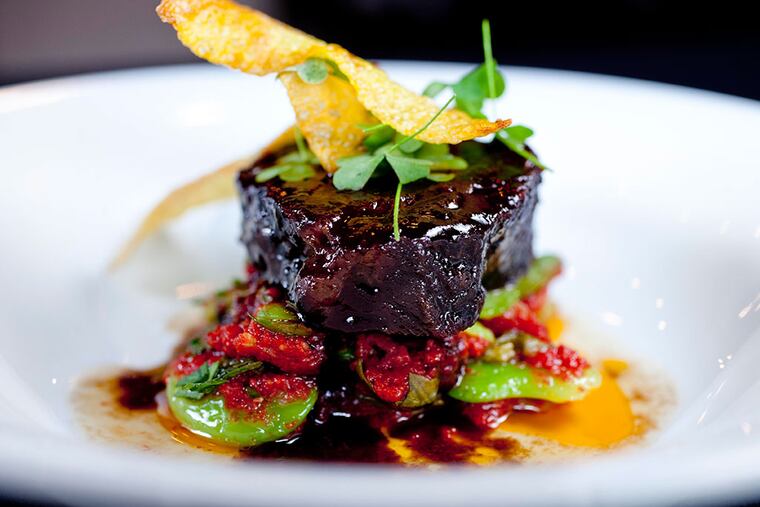 Slow-cooked beef cheek, meltingly tender over lima beans, heirloom tomato, sorrel, and saffron potato chips.