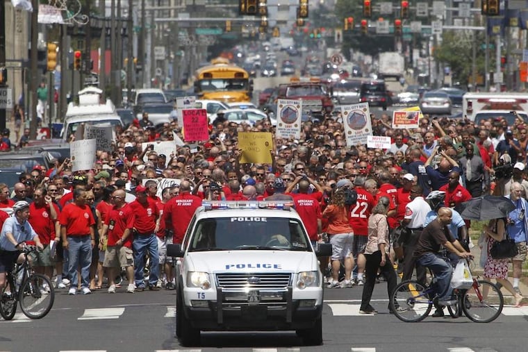 Members of the union that represents the Philadelphia fire department International Association of Fire Fighters Local 22 and the International Union marched down N. Broad St. to City Hall on Thursday afternoon July 26, 2012 to protest against Mayor Michael Nutter so that he sign the arbitration award for Local 22. ( ALEJANDRO A. ALVAREZ / STAFF PHOTOGRAPHER )
