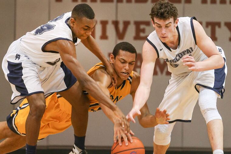 Penn Charter's Dylan Burnett dives for a loose ball between Episcopal's Jermaine Rhoden (left) and Nick Alikakos. Penn Charter prevailed, 52-36.