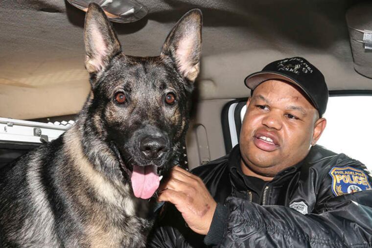 Thor, who is now retired from the Philadelphia Police Department, and his owner, Sgt. Alvin Outlaw, pictured at work in 2014.