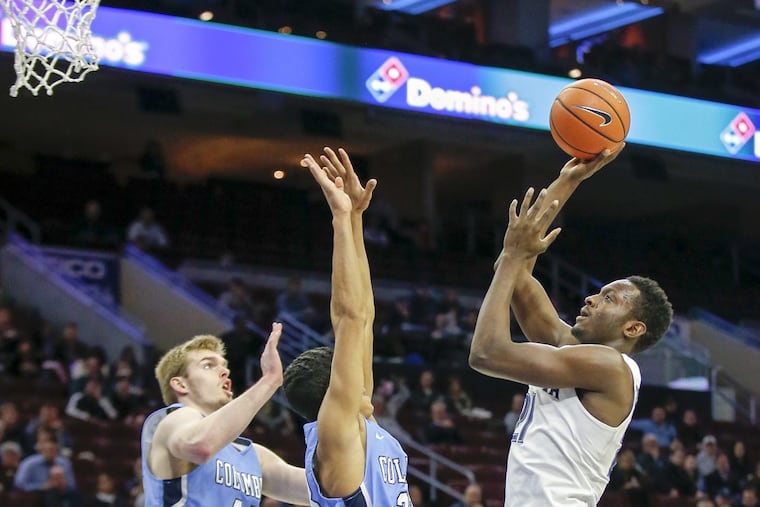 Villanova freshman forward Dhamir Cosby-Roundtree shoots over Columbia guard Tai Bibbs (center) in the season opener.