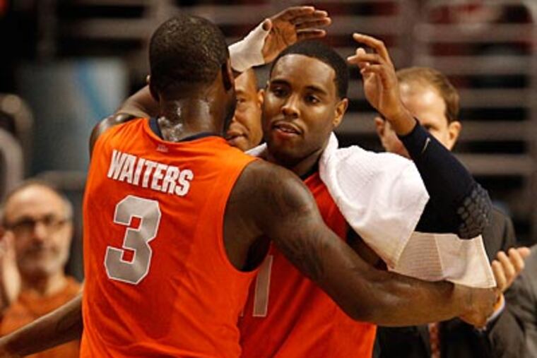 Syracuse's Scoop Jardine congratulates Dion Waters as he exits the game in the closing minutes. (Ron Cortes/Staff Photographer)