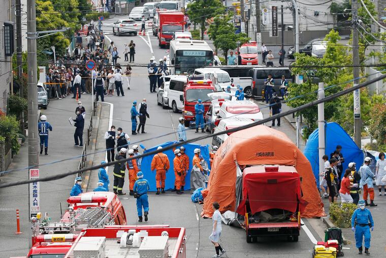 Rescuers work at the scene of an attack in Kawasaki, near Tokyo, Tuesday.