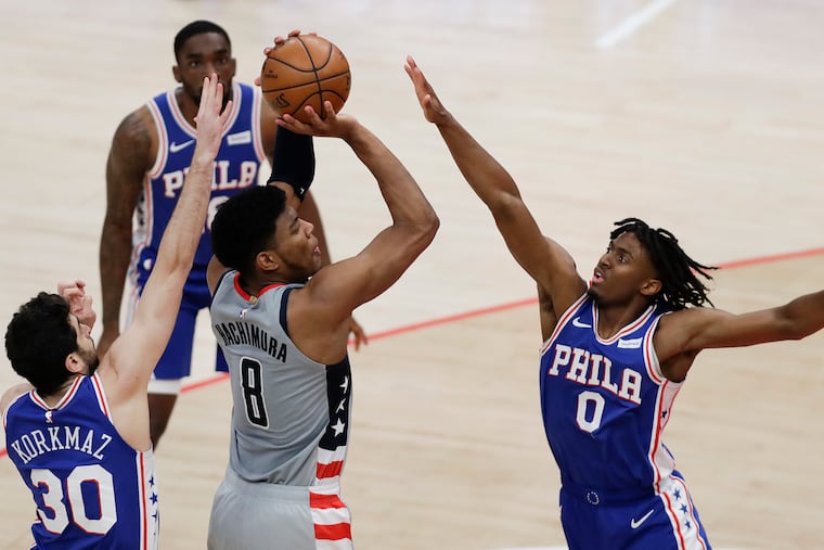 Team defense will be key for the Sixers, who will be without star Joel Embiid for Wednesday's Game 5. Here, Furkan Korkmaz (left) and Tyrese Maxey try to stop Wizards' forward Rui Hachimura in Game 4 on Monday.