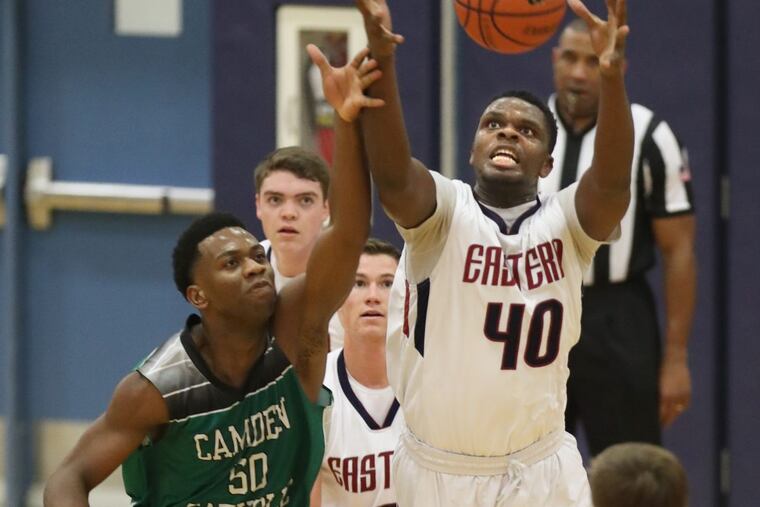 Uche Okafor, left, of Camden Catholic and Onye Okoro of Eastern go after a loose ball in the 2nd quarter of their season opener in boys' basketball on Dec. 15, 2017. CHARLES FOX / Staff Photographer