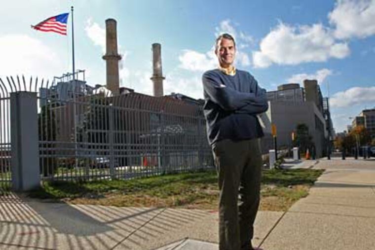 Jim Pew stands in front of the only coal-fired power plant that operates inside the city limits of Washington D.C. Pew is a staff attorney in Earthjustice's Washington, D.C. office. (Michael Bryant/Inquirer)