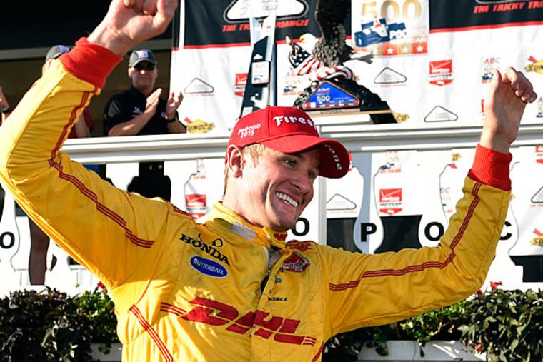 Ryan Hunter-Reay, of the United States, celebrates in Victory Lane after winning the Pocono IndyCar 500 auto race under caution, Sunday, Aug. 23, 2015, in Long Pond, Pa.
