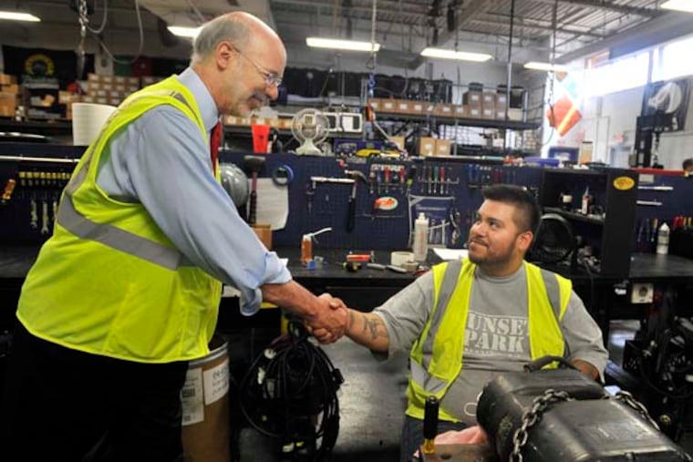 Democratic candidate for governor Tom Wolf shakes employee Jay Amigon's hand at the Mountain Productions facility in Wilkes-Barre. Wolf took a tour as part of his Fresh Start Tour to discuss the "Made in Pennsylvania" manufacturing plan. 7/24/2014 CREDIT: The Times Leader / AIMEE DILGER