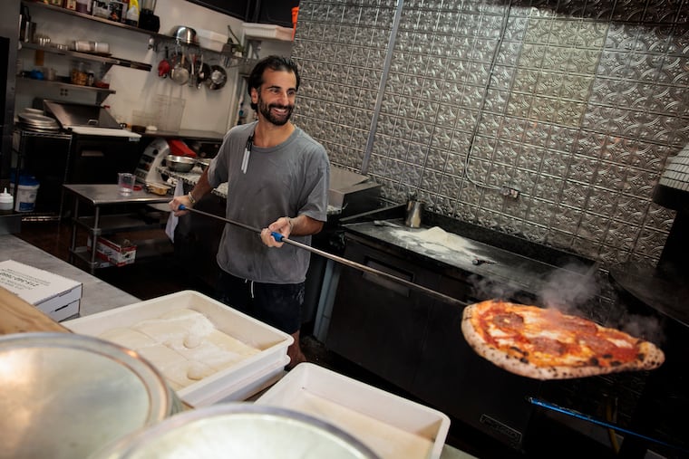 Roberto Carollo pulls a Ronzio pizza from the oven at Spuntino on Monday, Aug. 31, 2026 in Doylestown, Pa.
