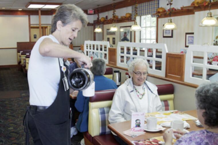A waitress pours coffee for patrons at Friendly's restaurant in Maine. The parent company of the Friendly's restaurant chain is filing for Chapter 11 bankruptcy protection. (Pat Wellenbach / Associated Press)