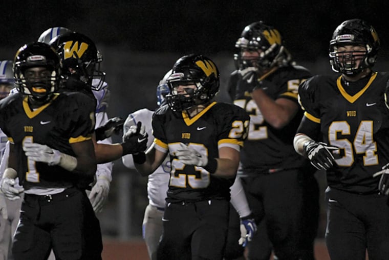 Archbishop Wood's Ryan Barrett (23) is congratulated by teammates after Barrett scored a touchdown against Great Valley during the first half of their PIAA Class AAA football quarterfinal game. (For the Inquirer/Joseph Kaczmarek)