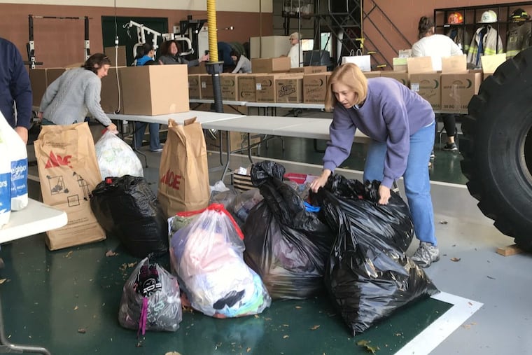 Darlene Short, right, volunteered Sunday at a donation drive organized by the Good Will Fire Co. in West Chester for victims displaced by the Barclay Friends nursing home fire Thursday.