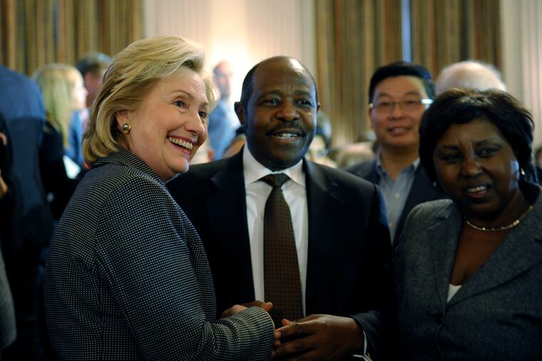 Former Secretary of State Hillary Rodham Clinton, left, posed for a photo with Paul Rusesabagina, center, and his wife, Tatiana, after a ceremony in which Clinton received the 2013 Lantos Human Rights Prize on Capitol Hill in Washington in December 2013. Rusesabagina received the 2011 Lantos Human Rights Prize.
