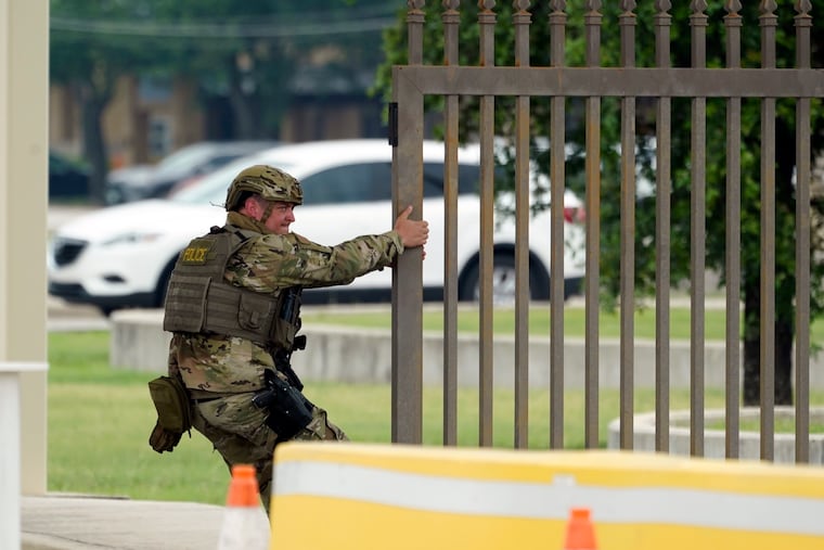 A military policeman closes a gate at JBSA-Lackland Air Force Base on Wednesday.