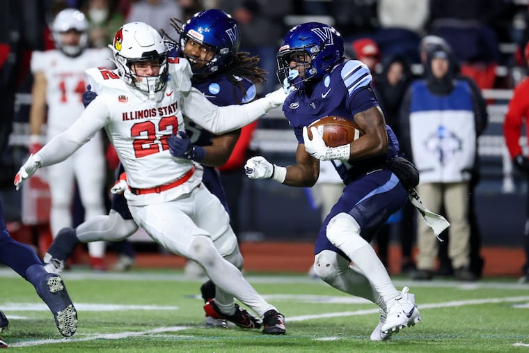 Villanova running back Ja'Briel Mace (right) is chased by Illinois State linebacker Nio Espinoza during Saturday night's FCS semifinal game at Villanova Stadium.