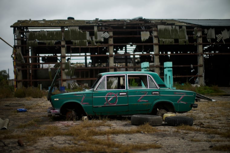 An abandoned car lies on the ground at a heavily damaged grain factory where Russian forces gathered destroyed vehicles in the recaptured town of Lyman, Ukraine on Tuesday.