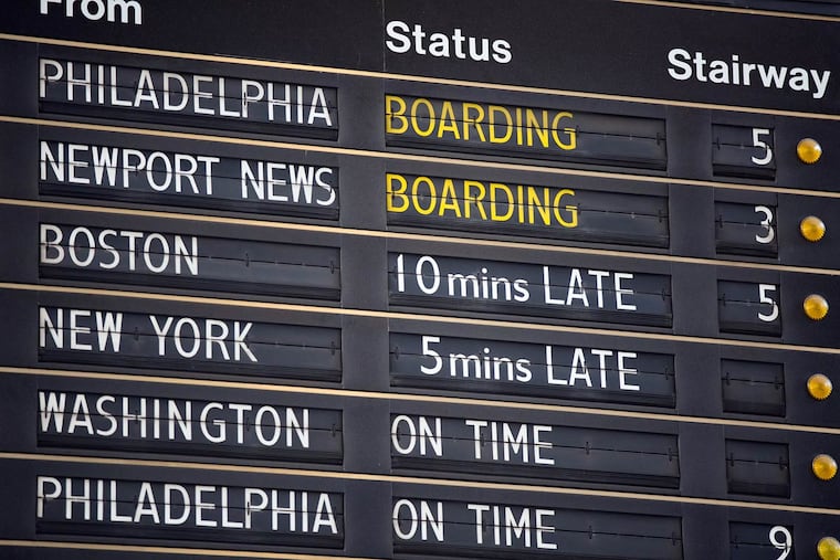 The sign at Amtrak's crowded 30th Street Station announces arrivals and departures.