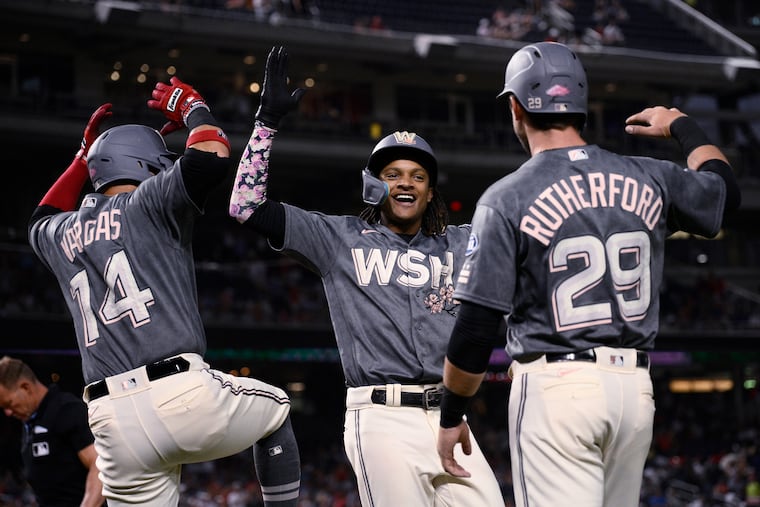 The Nationals' CJ Abrams, center, celebrates his three-run home run against the Phillies with Ildemaro Vargas and Blake Rutherford on Friday.