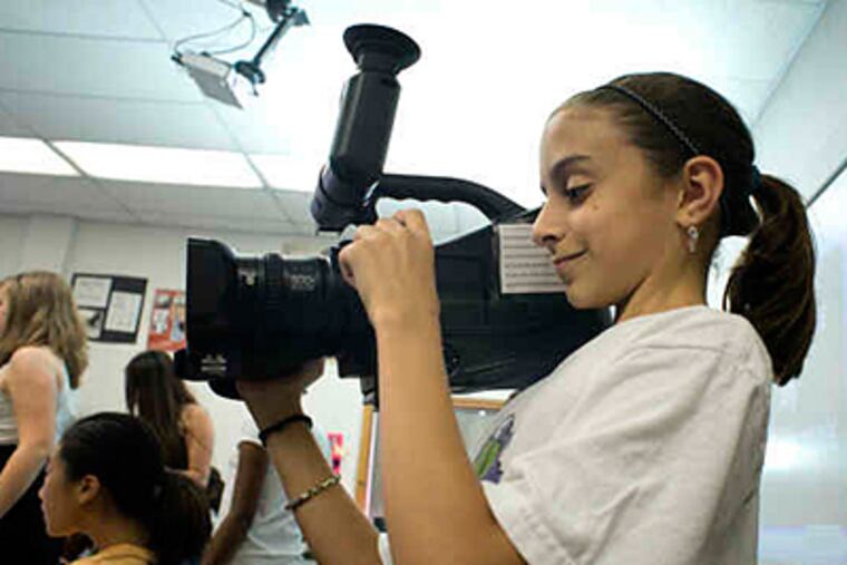 Jordan Whitney, 10, videotapes a website-design session. The 2-week camp includes robotics, gaming, animation. (Ed Hille / Staff)