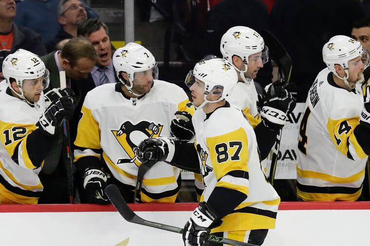 Pittsburgh Penguins center Sidney Crosby celebrates his first-period goal with his teammates on the bench against the Flyers on Monday, February 11, 2019 in Philadelphia.