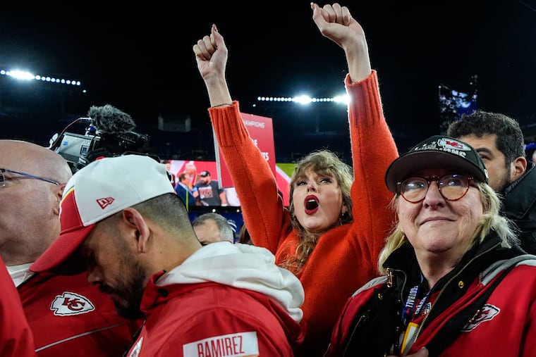 Taylor Swift, left, and Donna Kelce watch the Kansas City Chiefs receive the Lamar Hunt trophy after winning the AFC championship.