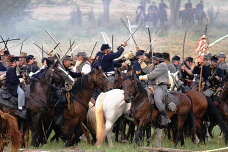 At a previous Gettysburg reenactment, the blues and grays clashed at Redding Farm in cavalry warfare. There could be up to 15,000 reenactors this year.